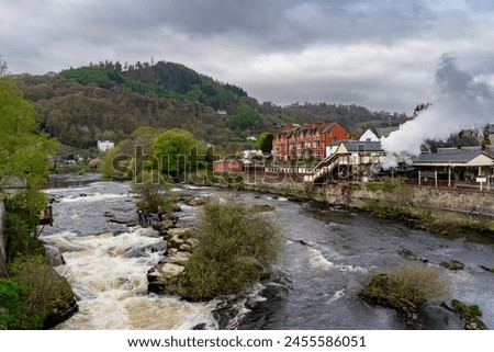 Canoeists going down the wier at Llangollen Royalty-Free Stock Photo #2455586051
