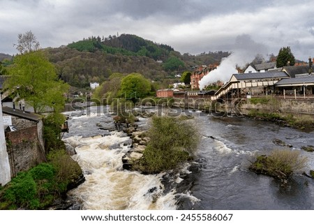 Canoeists going down the wier at Llangollen Royalty-Free Stock Photo #2455586067