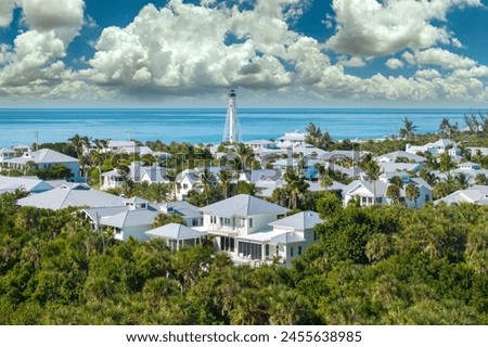 Wealthy waterfront residential area. Rich neighborhood with expensive vacation homes and white lighthouse in Boca Grande, small town on Gasparilla Island in southwest Florida Royalty-Free Stock Photo #2455638985