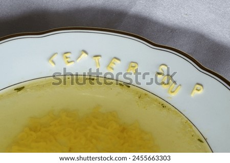 Alphabet soup with letters on the edge of the plate.