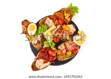 Assorted bruschetta with various toppings, isolated on white background. High resolution image.