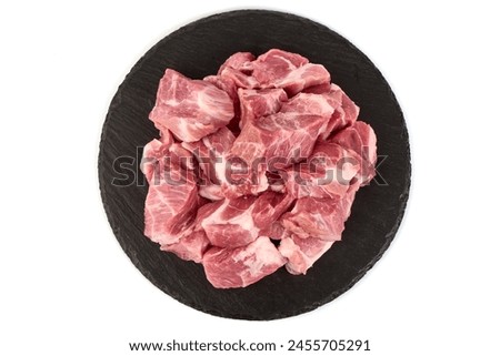 Raw pork pieces, isolated on white background. High resolution image.