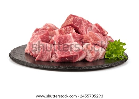 Raw pork pieces, isolated on white background. High resolution image.