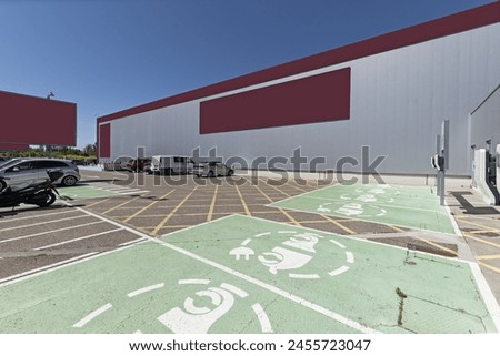 Parking area for electric charging vehicles in a shopping center and conventional fuel