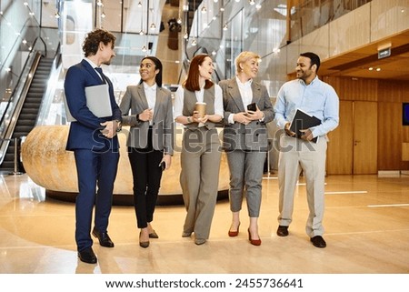 Multicultural business people networking in a modern lobby. Royalty-Free Stock Photo #2455736641