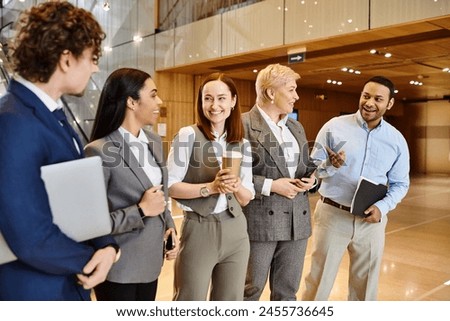 Multicultural business professionals gather in a lobby for a meeting. Royalty-Free Stock Photo #2455736645