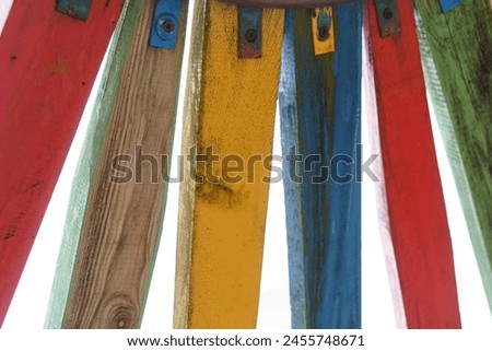 A group of multicolored wooden boards stacked on top of each other, creating a vibrant visual arrangement. Royalty-Free Stock Photo #2455748671