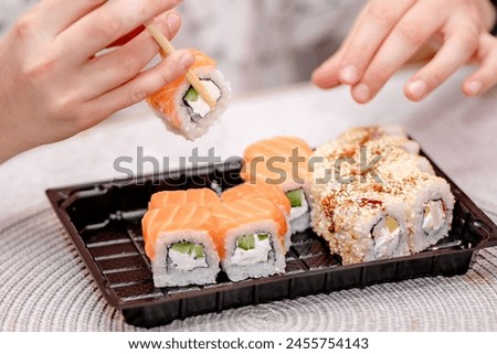  Maki sushi, or sushi rolls, are made by wrapping sushi rice and various ingredients in seaweed (nori) and then slicing them into bite-sized pieces.  Royalty-Free Stock Photo #2455754143