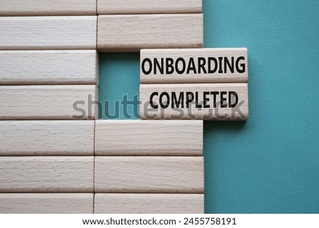 Onboarding Completed symbol. Concept word Onboarding Completed on wooden blocks. Beautiful grey green background. Business and Onboarding Completed concept. Copy space