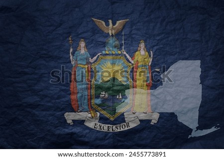 colorful big national flag and map of new york state on a grunge old paper texture background