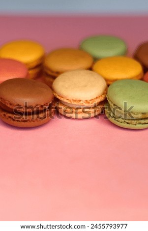 Colorful macarons on pink background. Selective focus.