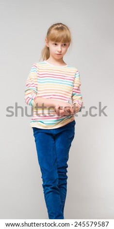 portrait of cute little girl on a gray background