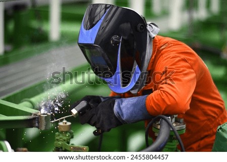 Welding works at tanker ship manifold area.  Royalty-Free Stock Photo #2455804457