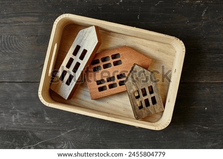 A studio photo of small toy wooden houses