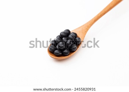 Black soybeans on a white background.