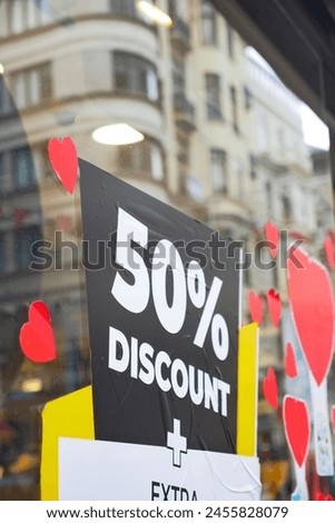 Large Sale text letters on red background on clothing store .