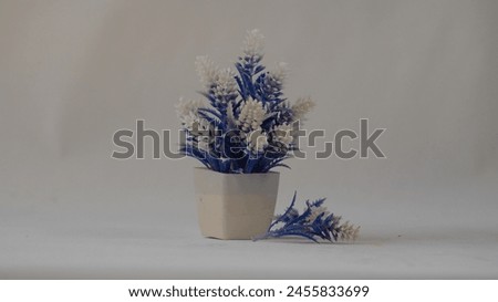 Close up picture of plastic pot and plastic flower . Photography of plastic pot . Stock photography.