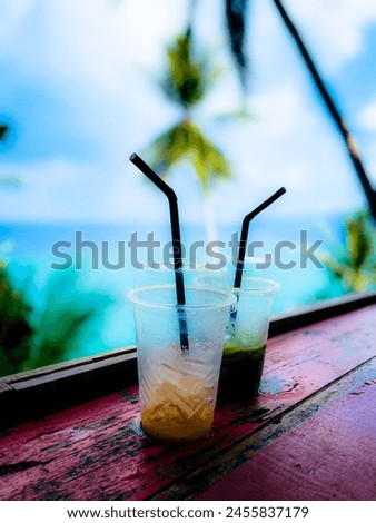 beautiful panorama overlooking the sea, aperitif with sea view, palm trees, glasses with fresh drinks, glasses with cocktails, holidays and relaxation Royalty-Free Stock Photo #2455837179