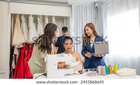 Fashion design concept, young stylish woman fashion designer working in studio office, small business owner creating new fashion design cloth in atelier.