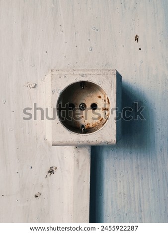 Picture of a dirty, rusty and old electrical socket