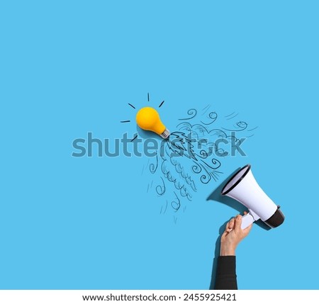 Attention and announcement concept with an idea light bulb flying to the sky like a rocket - Flat lay Royalty-Free Stock Photo #2455925421