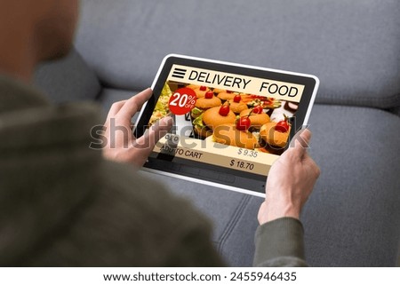 hands holding digital tablet with app delivery food wine screen.