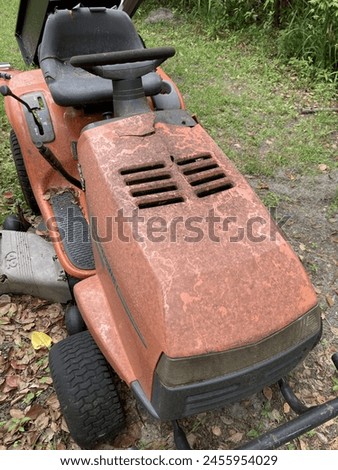 Lawnmower waiting to mow the yard Royalty-Free Stock Photo #2455954029
