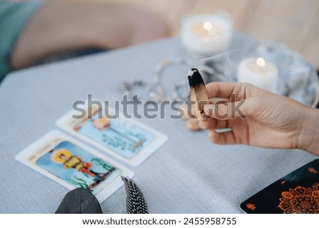 A woman is making tarot layout on the table. High quality photo