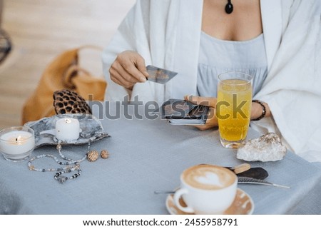 A woman is making tarot layout on the table. High quality photo