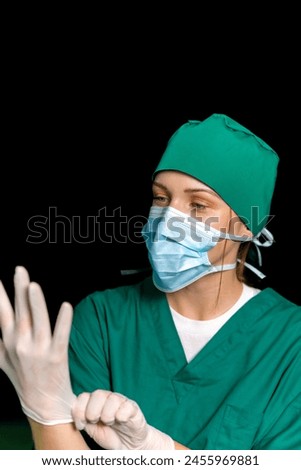 female caucasian nurse wearing medical gloves for protection in operation. er doctor wearing mask and clean gloves before examine. specialist surgical woman putting rubber gloves on hand to perform.