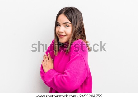 pretty hispanic woman shrugging, feeling confused and uncertain, doubting with arms crossed and puzzled look