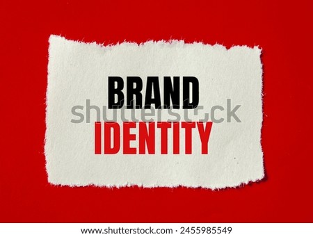 Brand identity words written on ripped paper with red background. Conceptual brand identity symbol. Copy space.