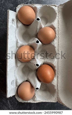 Five natural eggs in a basket, top view 