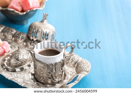 Traditional Turkish coffee and Turkish delight on blue wooden background