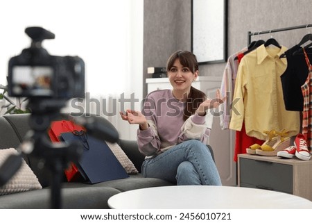 Smiling fashion blogger explaining something while recording video at home Royalty-Free Stock Photo #2456010721
