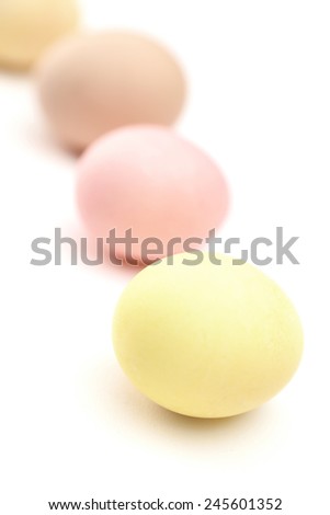 Rainbow of multicolored hen's eggs, isolated on white
