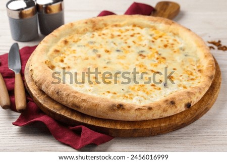 Delicious cheese pizza on white wooden table, closeup