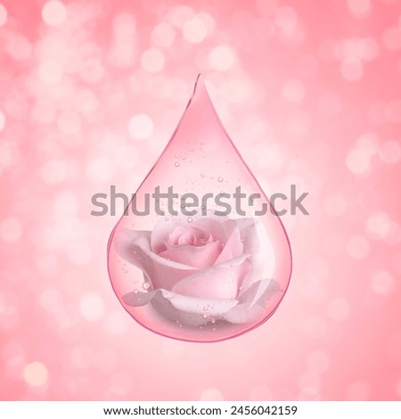 Drop of rose essential oil with flower on beige pink background, bokeh effect