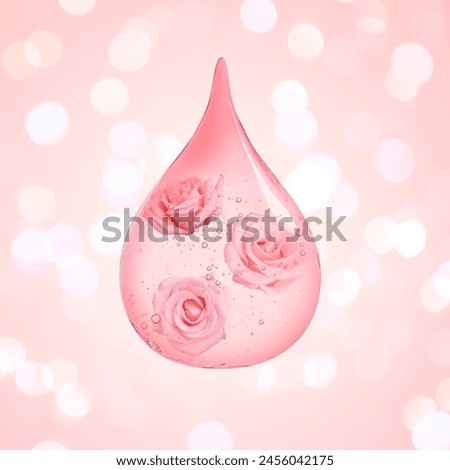 Drop of rose essential oil with flowers on beige pink background, bokeh effect