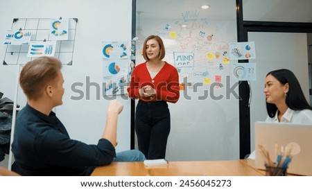 Closeup of young leader present business project with confident by using mind map and colorful sticky notes surrounded by colleague and project manager brainstorming about project. Immaculate. Royalty-Free Stock Photo #2456045273