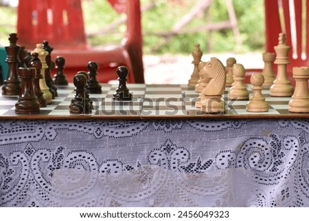 A chess board played by two people is photographed close up