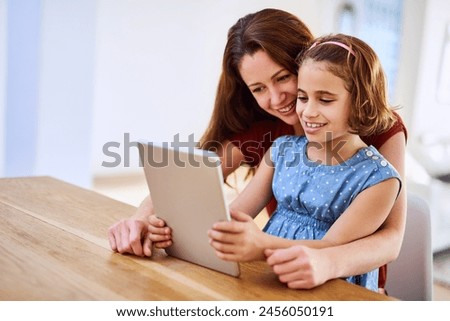 Mother, girl and tablet for learning in home, online play and remote class or education at table. Daughter, mama and streaming cartoon or games for child development, bonding and support in childhood