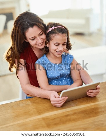 Mother, girl and tablet for movie in home, online play and remote learning or education at table. Daughter, mama and streaming cartoon or app for child development, bonding and support in childhood