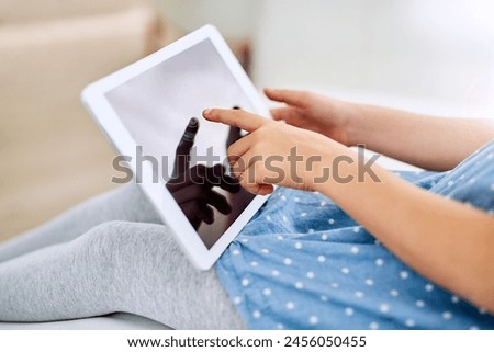 Hands, tablet screen and child in home on sofa for game, show or streaming movie in living room. Kid, fingers and digital tech for learning, education or watch cartoon on app display online in lounge