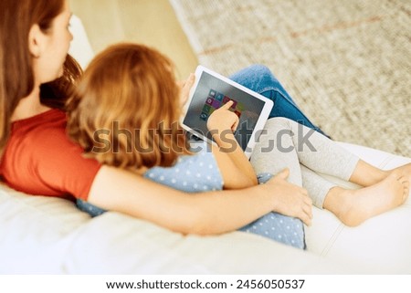 Mother, girl and tablet for games in home, online play and remote learning or education on couch. Daughter, mama and streaming cartoon or app for mind development, bonding and support in childhood