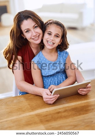 Mother, girl and tablet in portrait in home, online class and remote learning or education at table. Daughter, mama and streaming cartoon or games for development, bonding and support in childhood