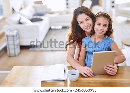 Mother, girl and tablet in portrait at table, online class and remote learning or education in home. Daughter, mama and streaming cartoon or app for development, bonding and support in childhood