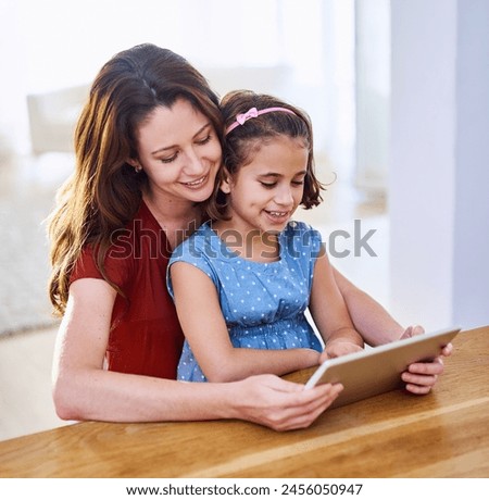 Mother, girl and tablet for movie at table, online play and remote learning or education in home. Daughter, mama and streaming cartoon or games for child development, bonding and support in childhood