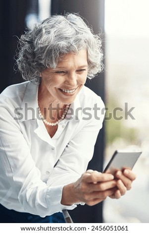 Mature, business and woman and typing on smartphone, web search and internet browsing or mobile connection. Communication, technology and online laugh for meme on work break, happy for notification