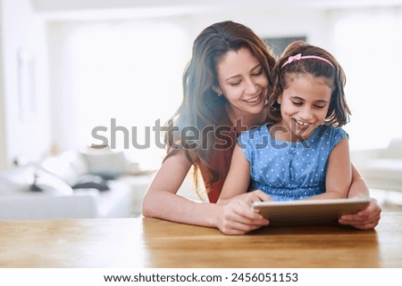 Mother, girl and tablet for games at table, online play and remote learning or education in home. Daughter, mama and streaming cartoon or app for child development, bonding and support in childhood